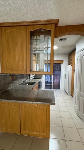 a kitchen with stainless steel appliances granite countertop a sink and a stove