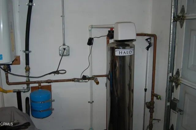 a kitchen with granite countertop cabinets and chair