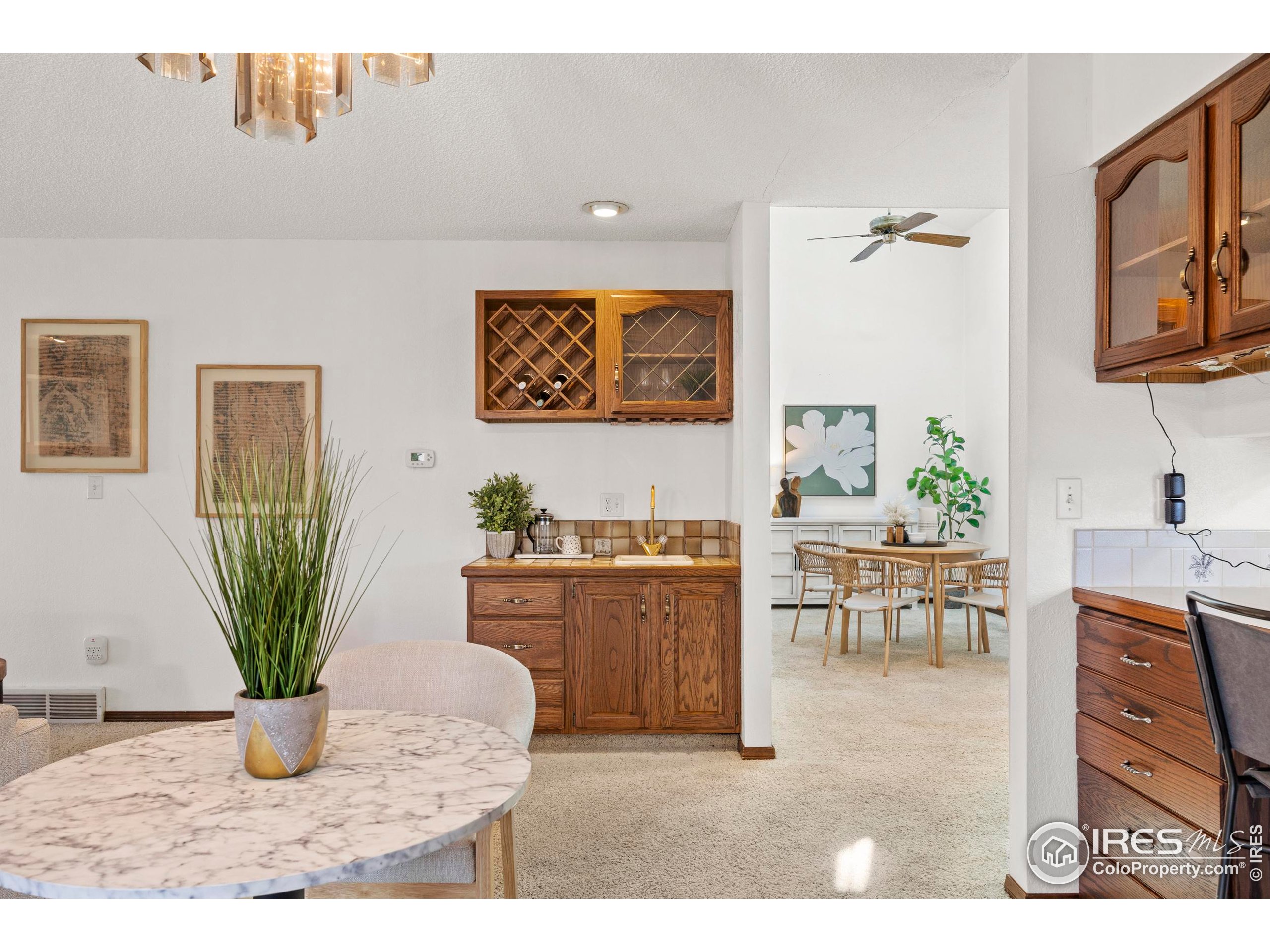903 Conifer Court Windsor, CO 80550 - Photo 15 of 33 a living room with furniture a potted plant and a table