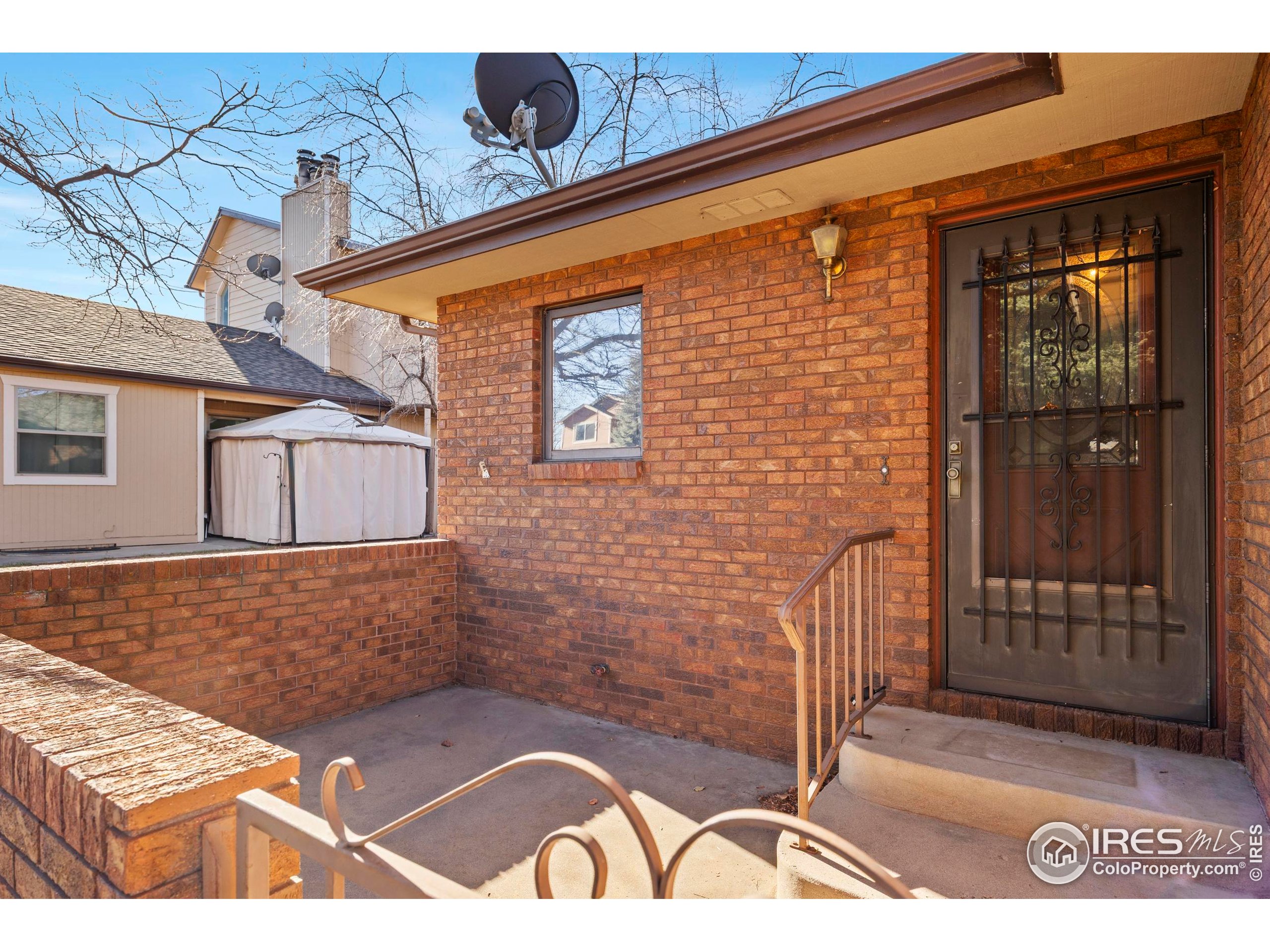 903 Conifer Court Windsor, CO 80550 - Photo 2 of 33 a view of a brick house with a door