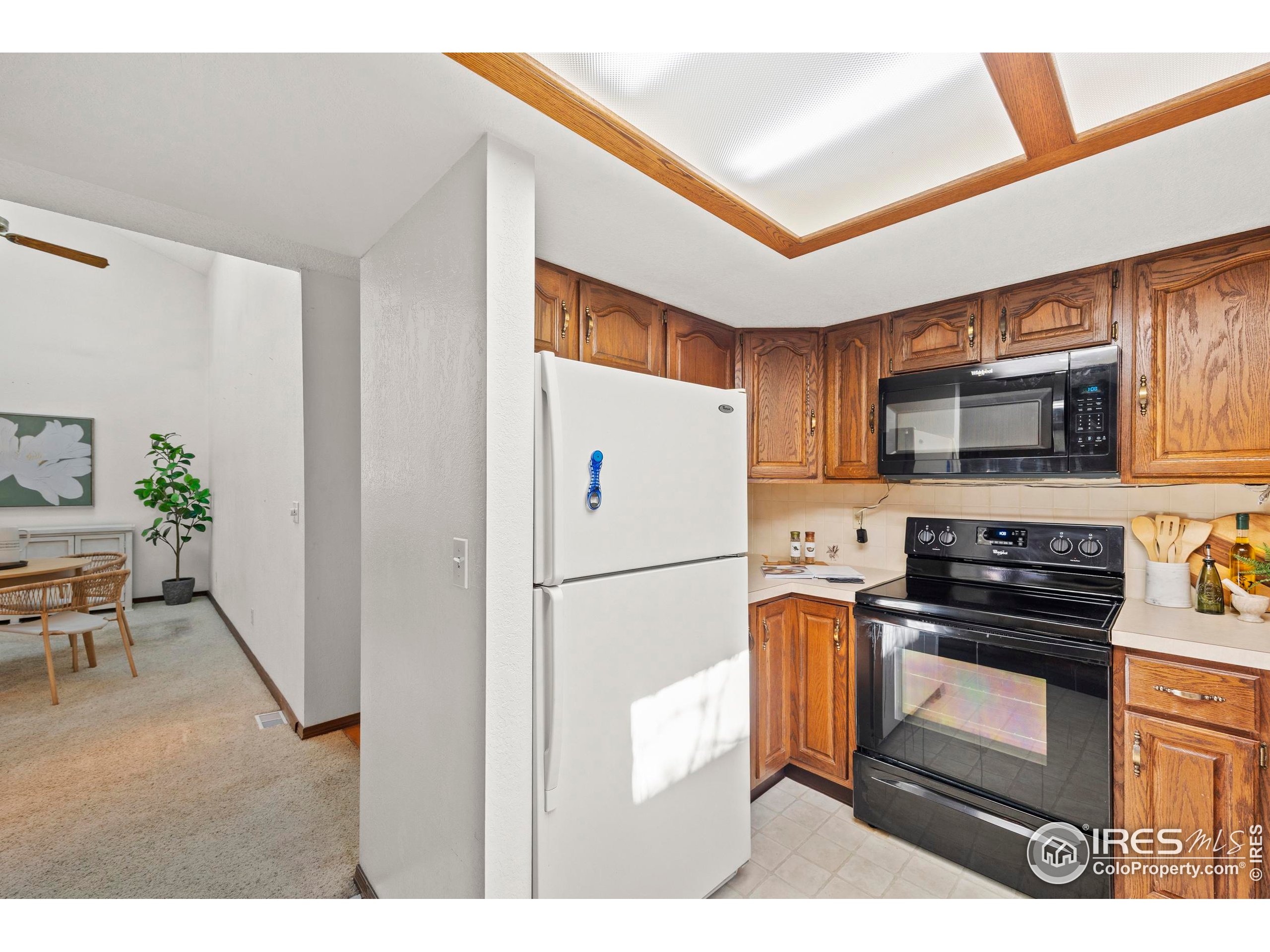 903 Conifer Court Windsor, CO 80550 - Photo 10 of 33 a kitchen with stainless steel appliances granite countertop a refrigerator stove a sink and a microwave