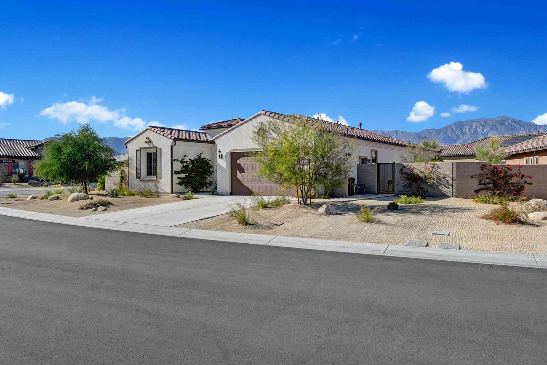 51 Merlot Rancho Mirage, CA 92270 - Photo 30 of 50 070 FRONT OF HOUSE ANGLED TO MOUNTAINS M