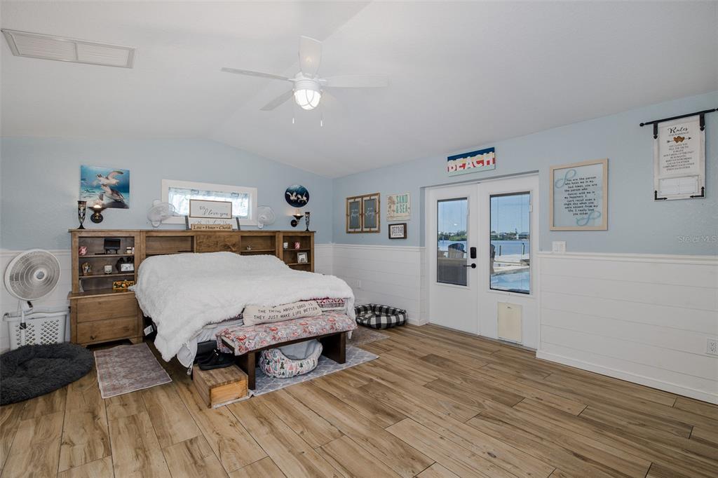 8211 Hayward Lane Port Richey, FL 34668 - Photo 15 of 65 a bed room with a bed mirror and a window