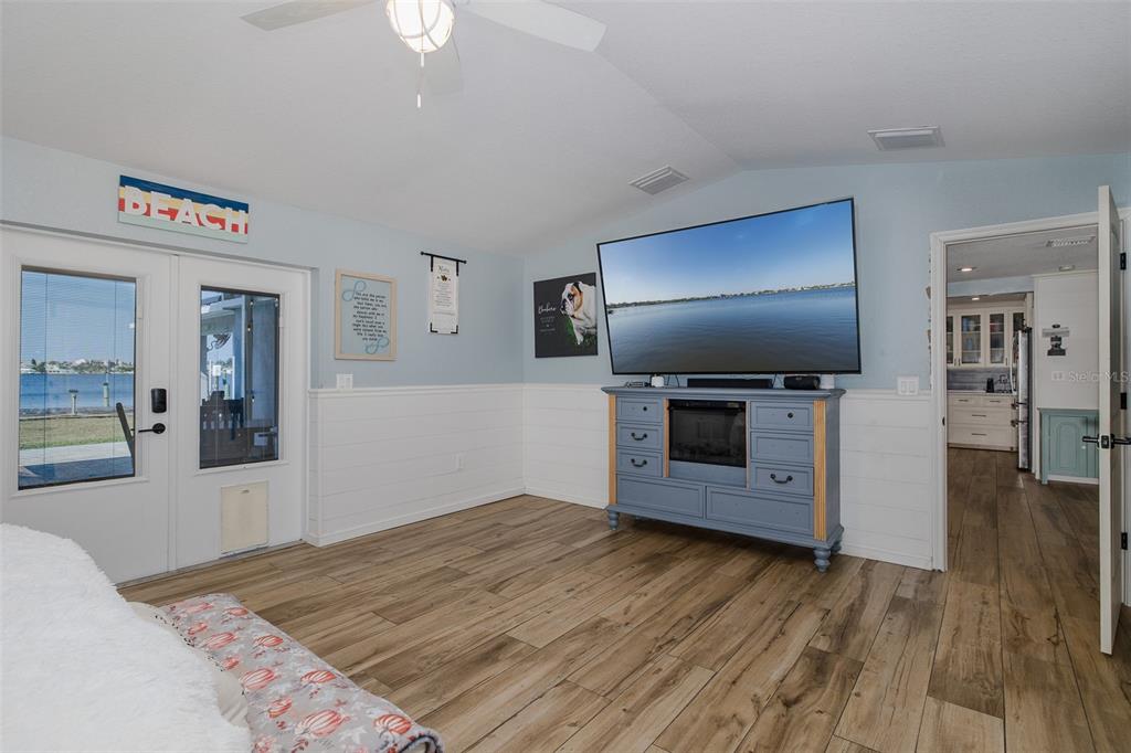 8211 Hayward Lane Port Richey, FL 34668 - Photo 17 of 65 a bedroom with a bed and a flat screen tv