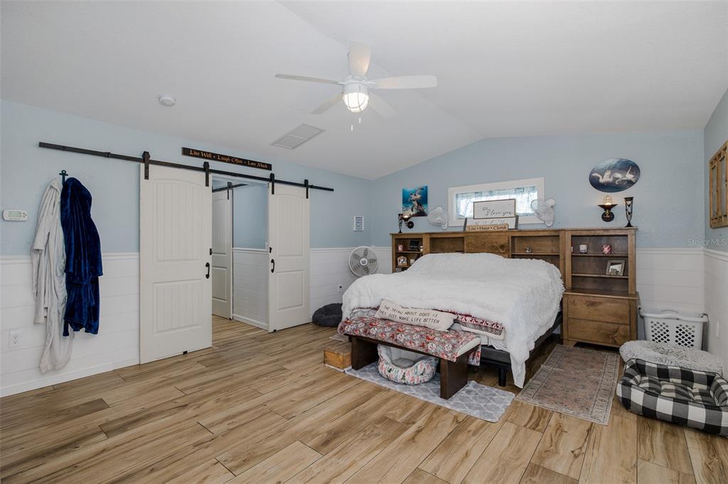 8211 Hayward Lane Port Richey, FL 34668 - Photo 18 of 65 a spacious bedroom with a bed and a table