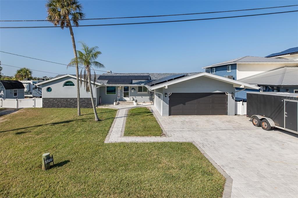 8211 Hayward Lane Port Richey, FL 34668 - Photo 2 of 65 a backyard of a house with table and chairs