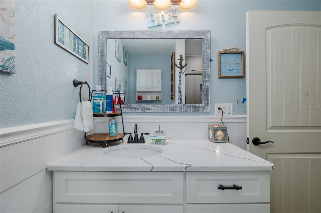 8211 Hayward Lane Port Richey, FL 34668 - Photo 26 of 65 a bathroom with a sink and a mirror