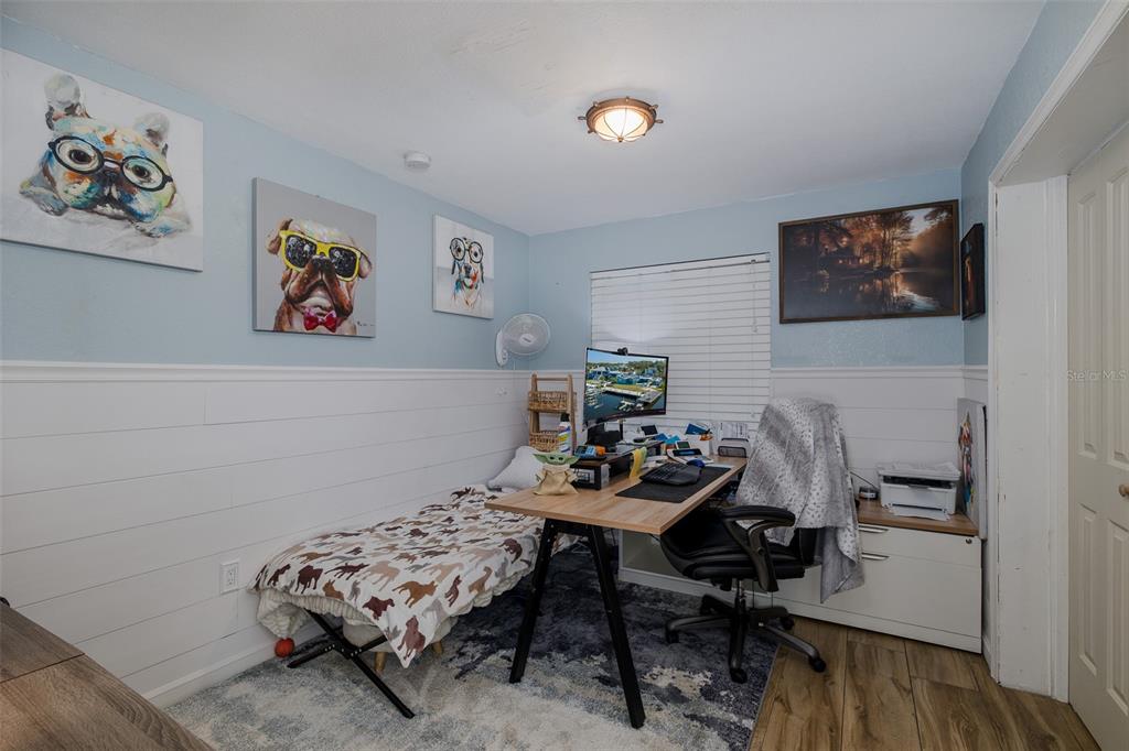 8211 Hayward Lane Port Richey, FL 34668 - Photo 27 of 65 a bedroom with a bed and furniture