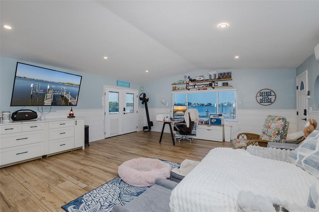 8211 Hayward Lane Port Richey, FL 34668 - Photo 29 of 65 a bedroom with furniture and a flat screen tv