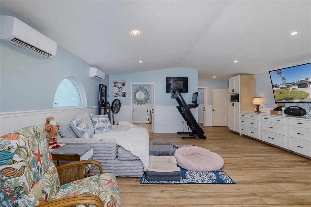 8211 Hayward Lane Port Richey, FL 34668 - Photo 32 of 65 a living room with furniture and a wooden floor