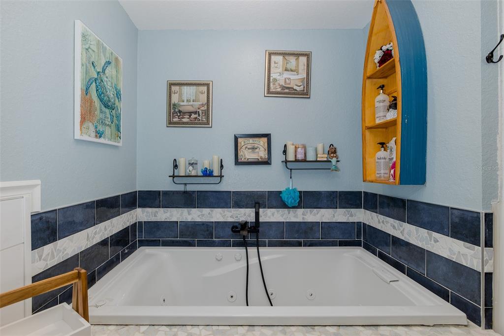 8211 Hayward Lane Port Richey, FL 34668 - Photo 35 of 65 a bathroom with a bathtub and a window