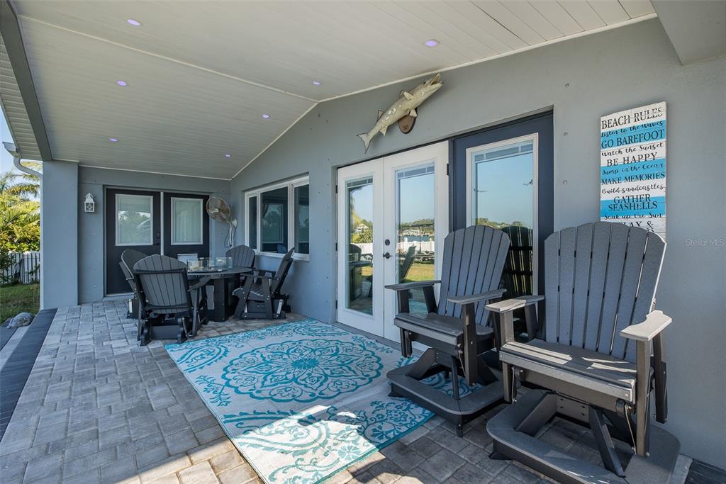 8211 Hayward Lane Port Richey, FL 34668 - Photo 45 of 65 a living room with furniture a rug and large windows