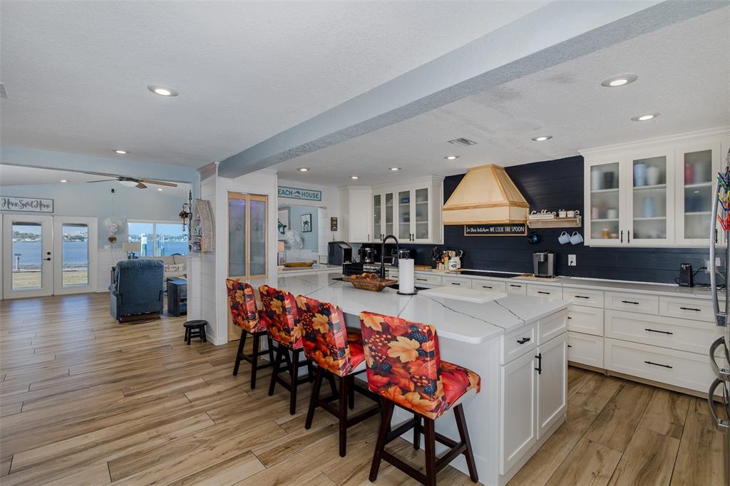 8211 Hayward Lane Port Richey, FL 34668 - Photo 7 of 65 a kitchen with stainless steel appliances a stove a sink dishwasher and a refrigerator with wooden floor