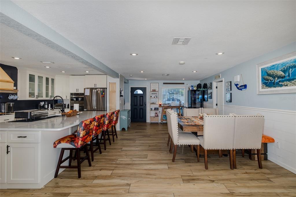 8211 Hayward Lane Port Richey, FL 34668 - Photo 9 of 65 a dining room with furniture and wooden floor