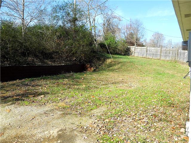 836 Cowan Road Dickson, TN 37055 - Photo 18 of 20 The level back yard is partially fenced and goes and goes back into the trees to an old dog pen.