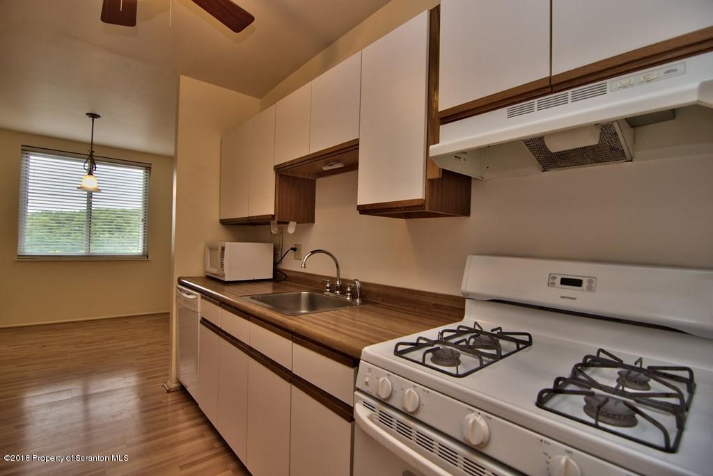 1610 Summit Pointe Scranton, PA 18508 - Photo 5 of 17 a kitchen with a stove and a sink