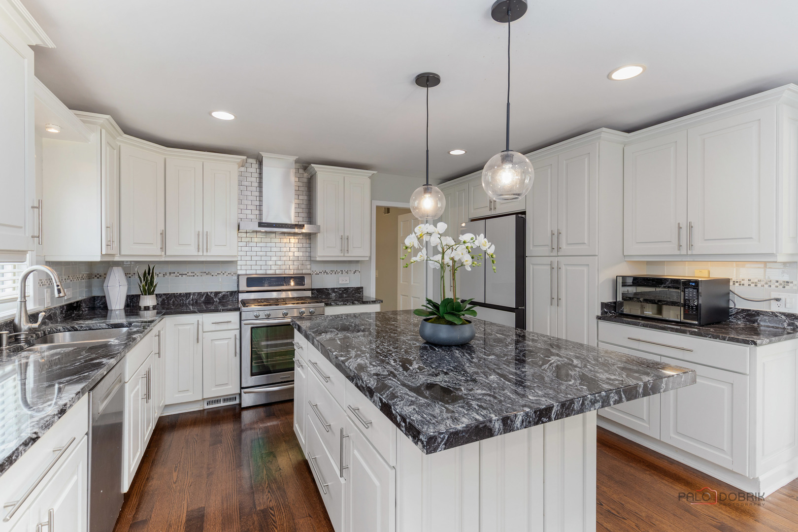 2965 Keystone Road Northbrook, IL 60062 - Photo 12 of 40 a kitchen with kitchen island granite countertop a sink a stove and cabinets
