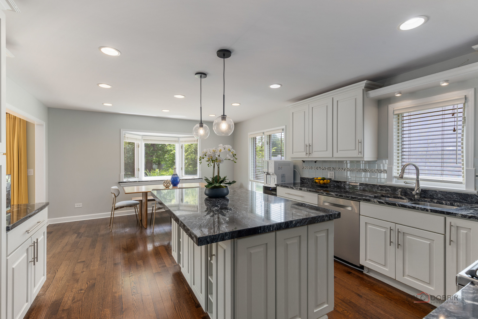 2965 Keystone Road Northbrook, IL 60062 - Photo 14 of 40 a kitchen with granite countertop a sink a counter top space and living room area