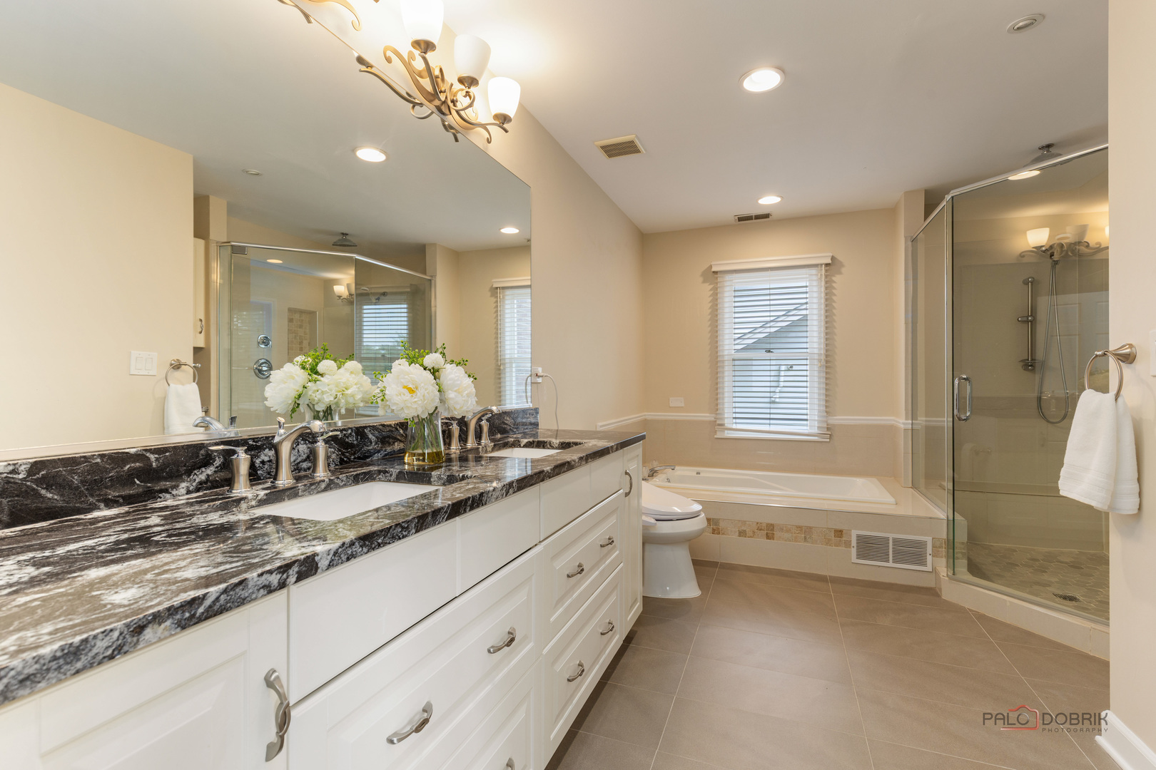 2965 Keystone Road Northbrook, IL 60062 - Photo 23 of 40 a bathroom with a double vanity sink a mirror and a bathtub