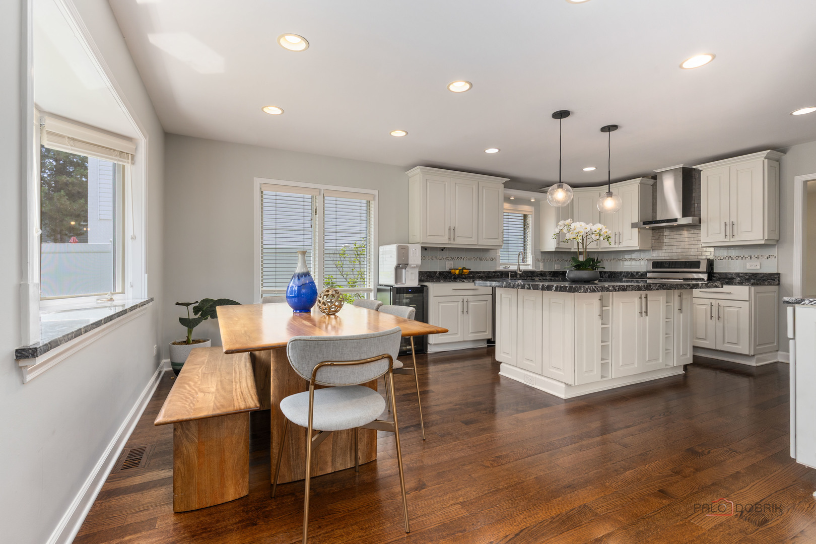 2965 Keystone Road Northbrook, IL 60062 - Photo 9 of 40 a dining room with kitchen island stainless steel appliances kitchen island furniture a wooden floor and a sink