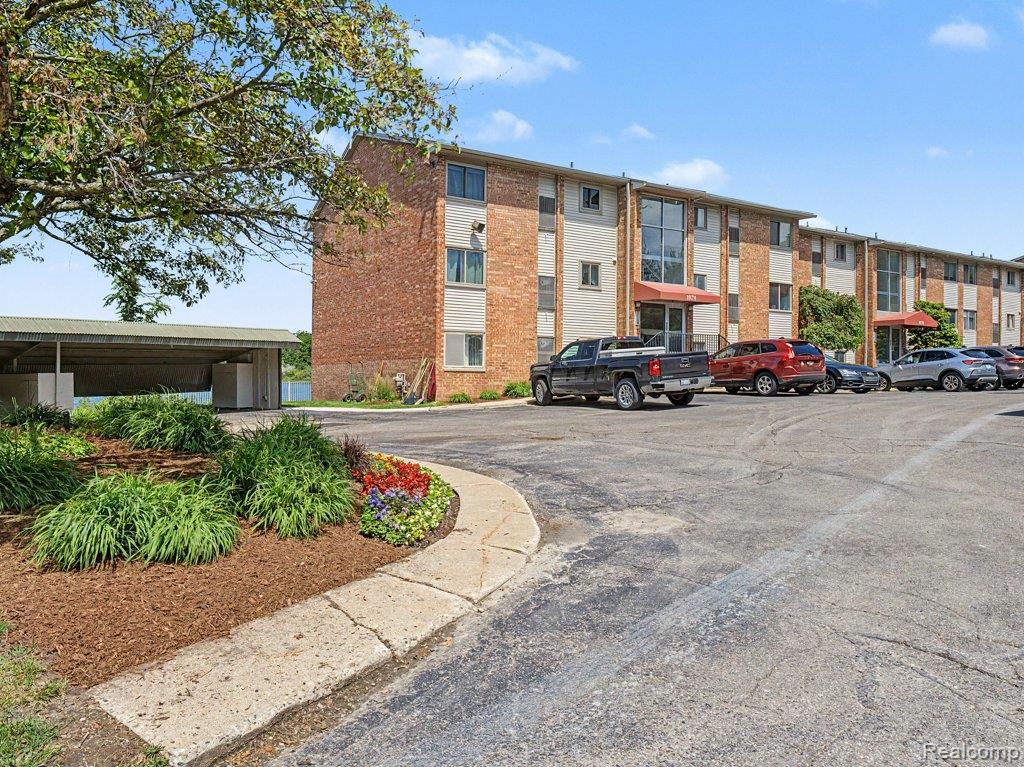 1974 Klingensmith Road, Unit 4 Bloomfield Hills, MI 48302 - Photo 1 of 35 Three-story brick building with multiple units and covered entryways