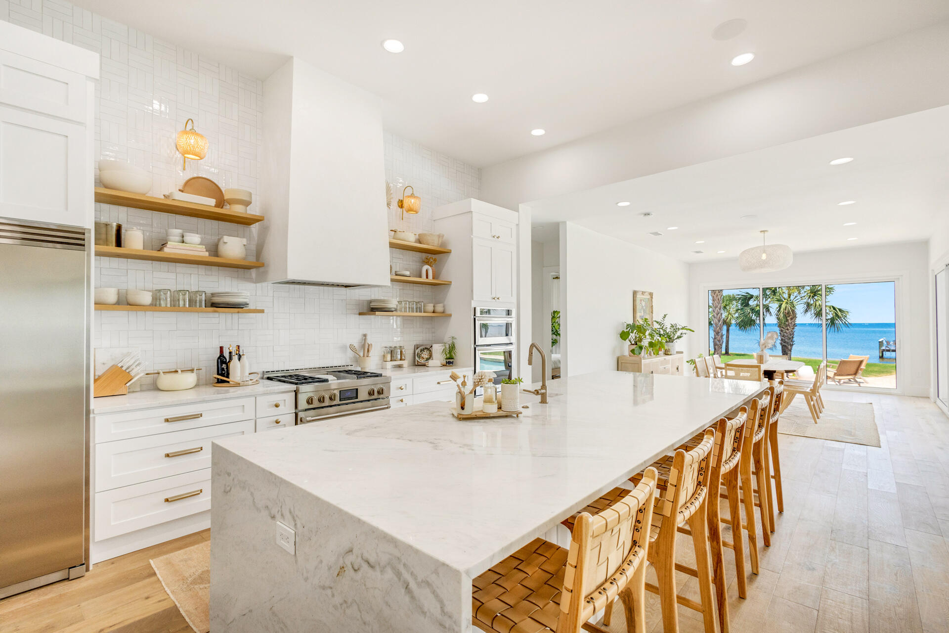1341 Driftwood Point Road Santa Rosa Beach, FL 32459 - Photo 10 of 55 a kitchen with stainless steel appliances a stove a sink a refrigerator and cabinets with wooden floor