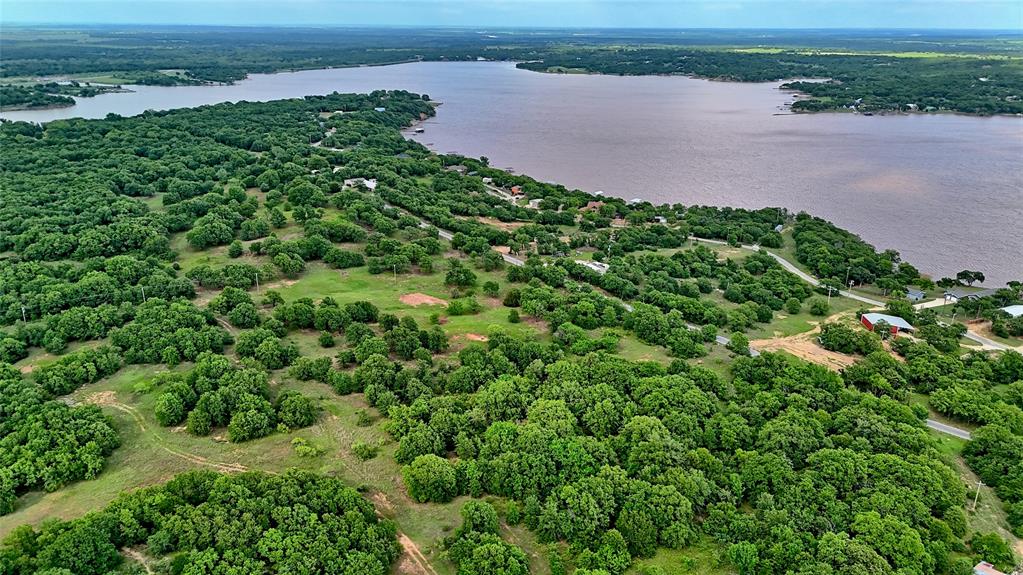 Tbd Tradewinds Road Nocona, TX 76255 - Photo 14 of 32 an aerial view of a yard with plants and large trees