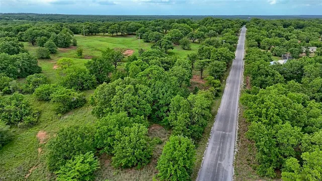 a sign board with a house in the background