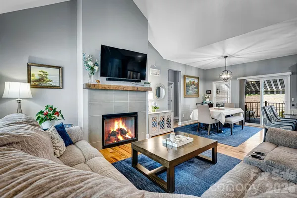 a living room with furniture fireplace and flat screen tv