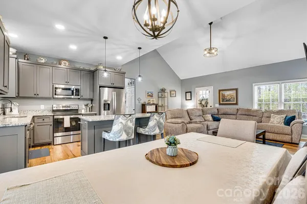 a large kitchen with a table and chairs