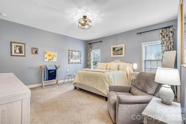 a spacious bedroom with a bed and a couch