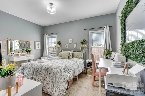 a bedroom with a large bed and potted plant