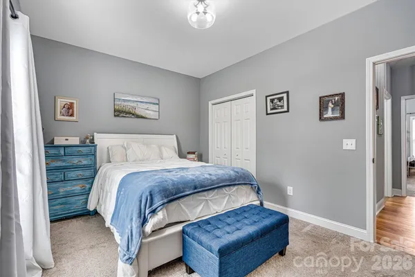 a bedroom with a bed and wall painting