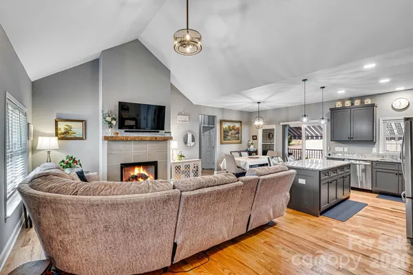 a living room with furniture fireplace and flat screen tv