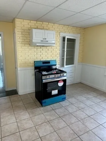 a kitchen with a stove and a refrigerator