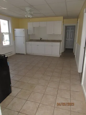 a view of a refrigerator and window in a kitchen