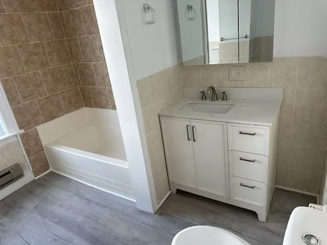 a bathroom with a sink a toilet and tub