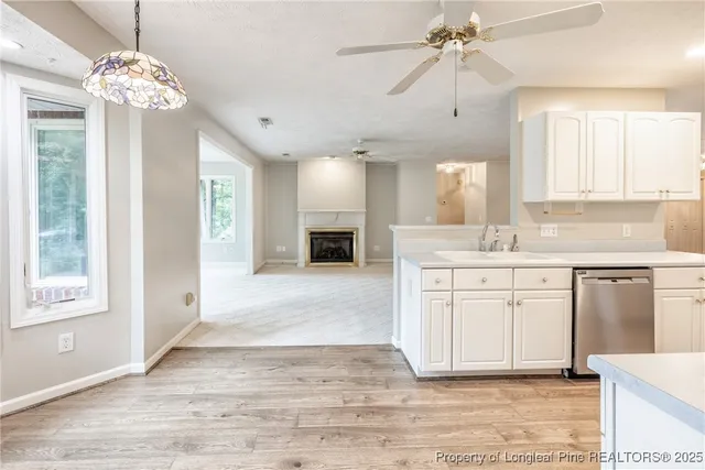 a spacious bathroom with a granite countertop sink a mirror a vanity and a bathtub