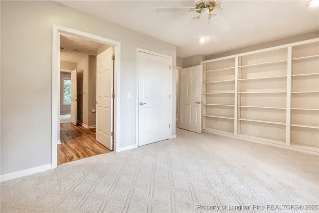 a view of empty room with a ceiling fan