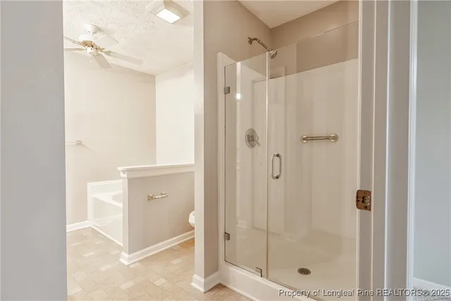 a bathroom with a shower and a glass door