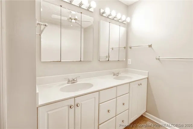 a bathroom with a sink double vanity and a mirror