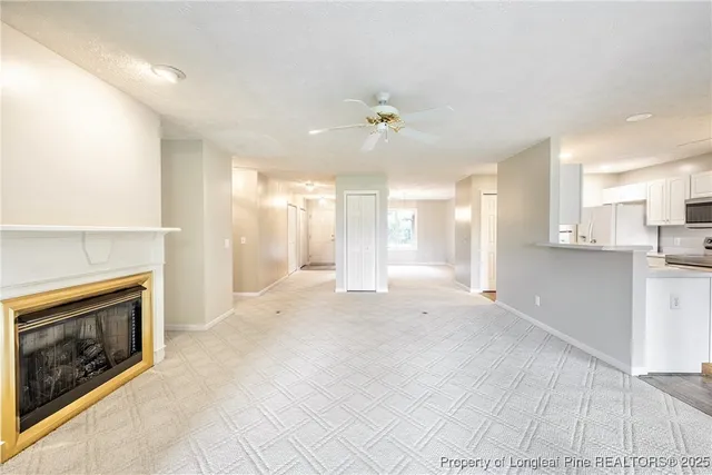 a view of a kitchen with a sink and a fireplace