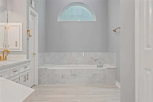 a bathroom with a bathtub and a sink