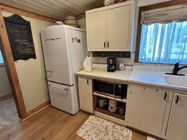 239 Ranch Road Joshua, TX 76058 - Photo 7 of 34 a view of a kitchen with fridge and wooden floor
