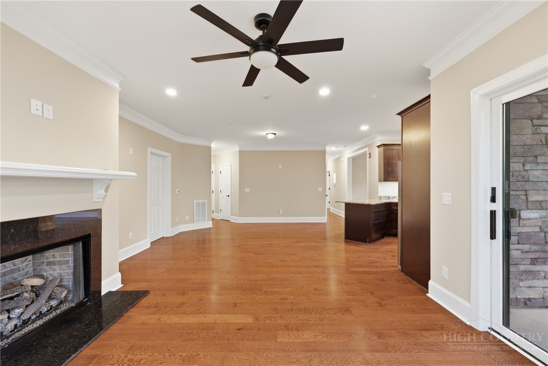 155 Gateway Drive, Unit 101 Boone, NC 28607 - Photo 13 of 50 a view of an empty room and kitchen with fireplace ceiling fan