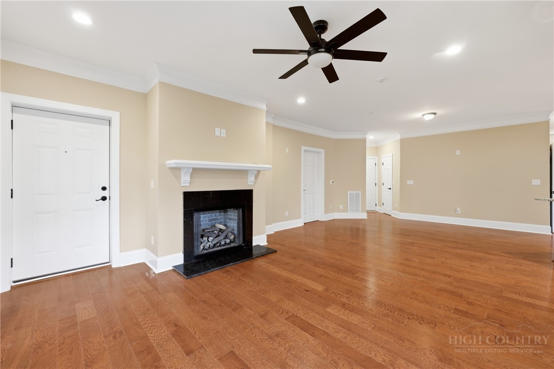 155 Gateway Drive, Unit 101 Boone, NC 28607 - Photo 14 of 50 an empty room with a fireplace and window