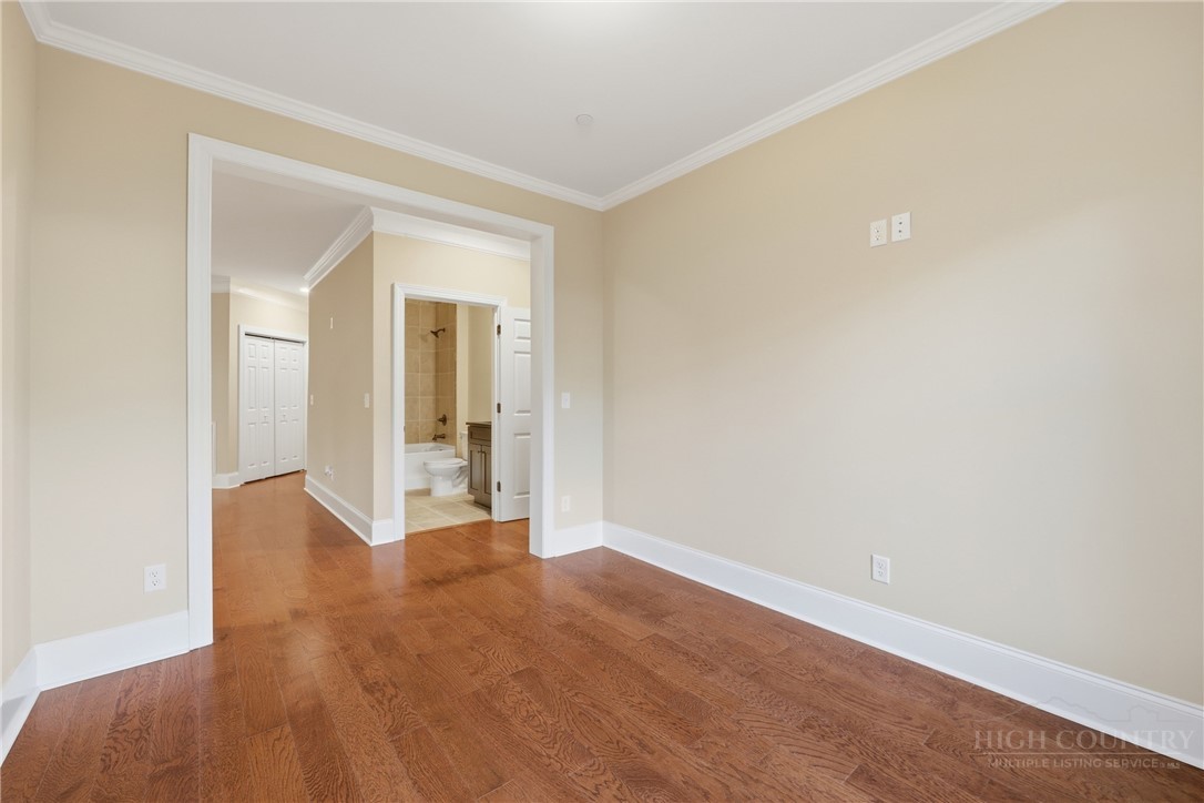 155 Gateway Drive, Unit 101 Boone, NC 28607 - Photo 16 of 50 a view of an empty room with wooden floor and a window