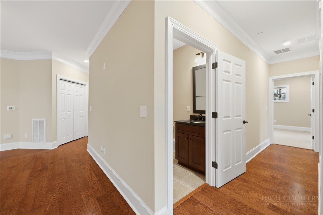 155 Gateway Drive, Unit 101 Boone, NC 28607 - Photo 20 of 50 a view of a hallway with wooden floor and cabinets