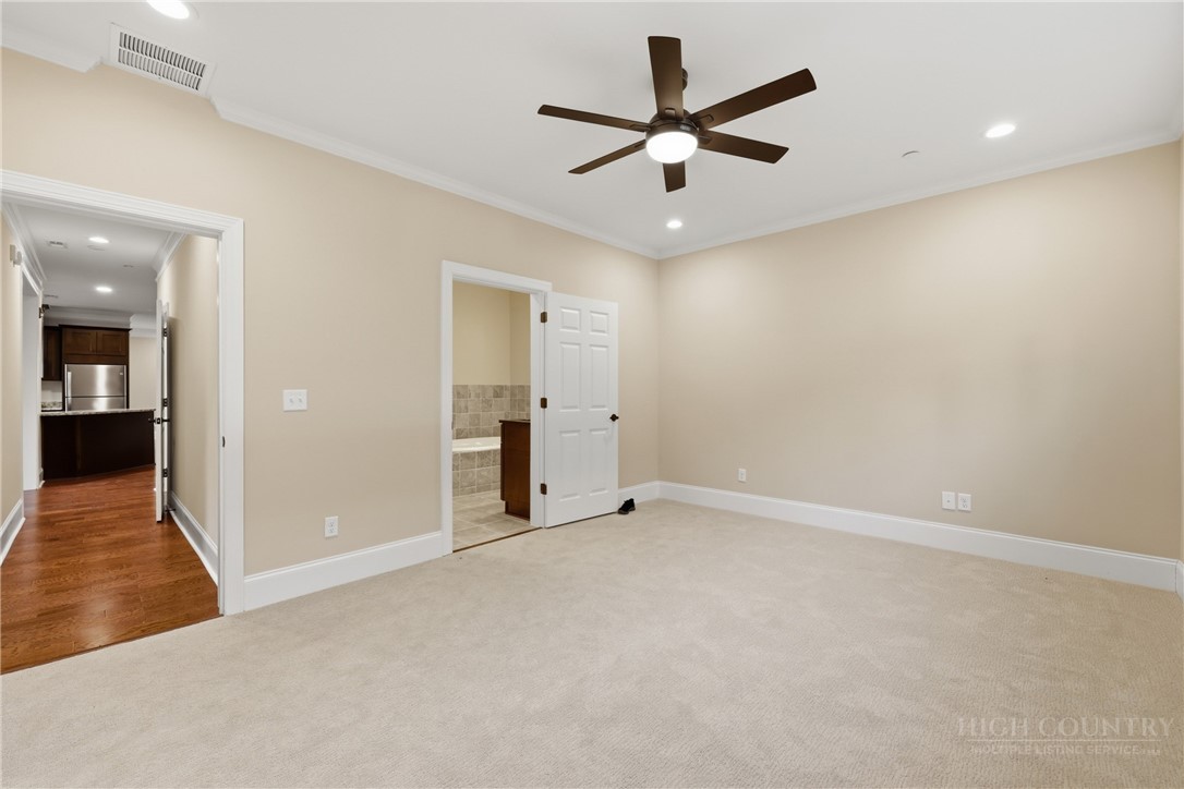155 Gateway Drive, Unit 101 Boone, NC 28607 - Photo 22 of 50 an empty room with fan and a ceiling fan
