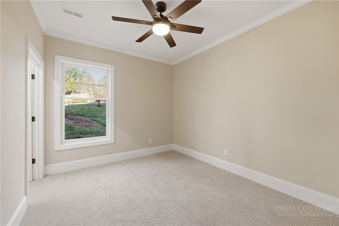 155 Gateway Drive, Unit 101 Boone, NC 28607 - Photo 29 of 50 an empty room with a window and a fan